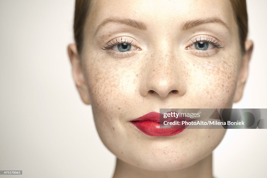 Young woman wearing bright red lipstick, portrait