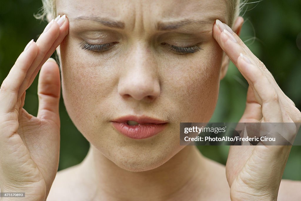 Woman rubbing temples