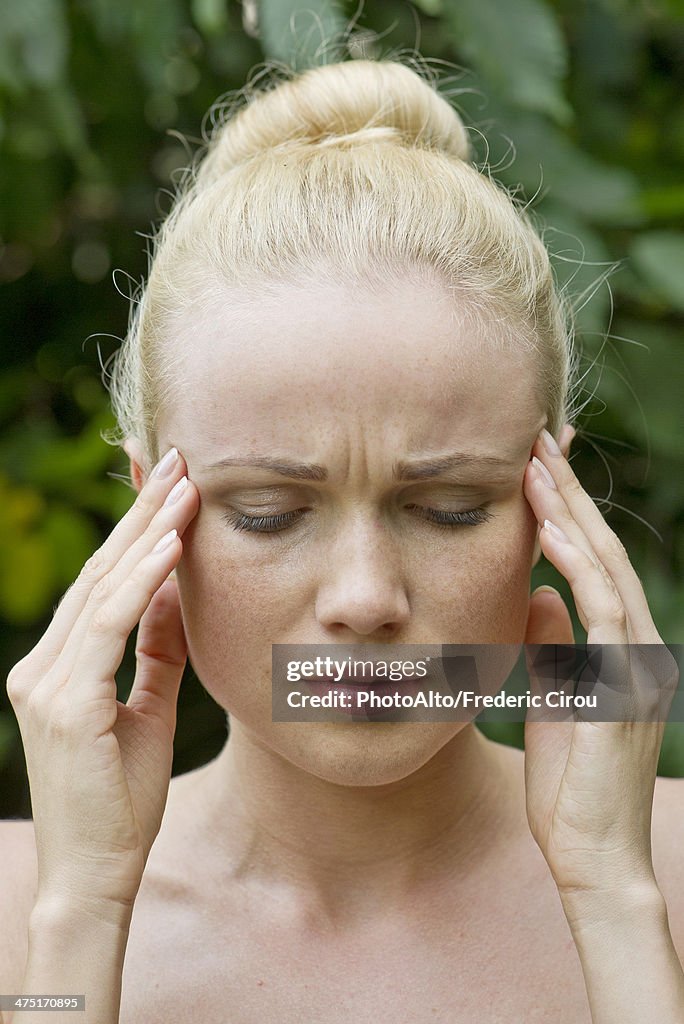 Woman rubbing temples