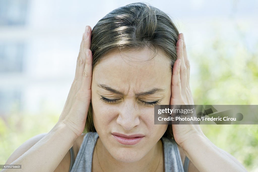 Distressed woman with head in hands