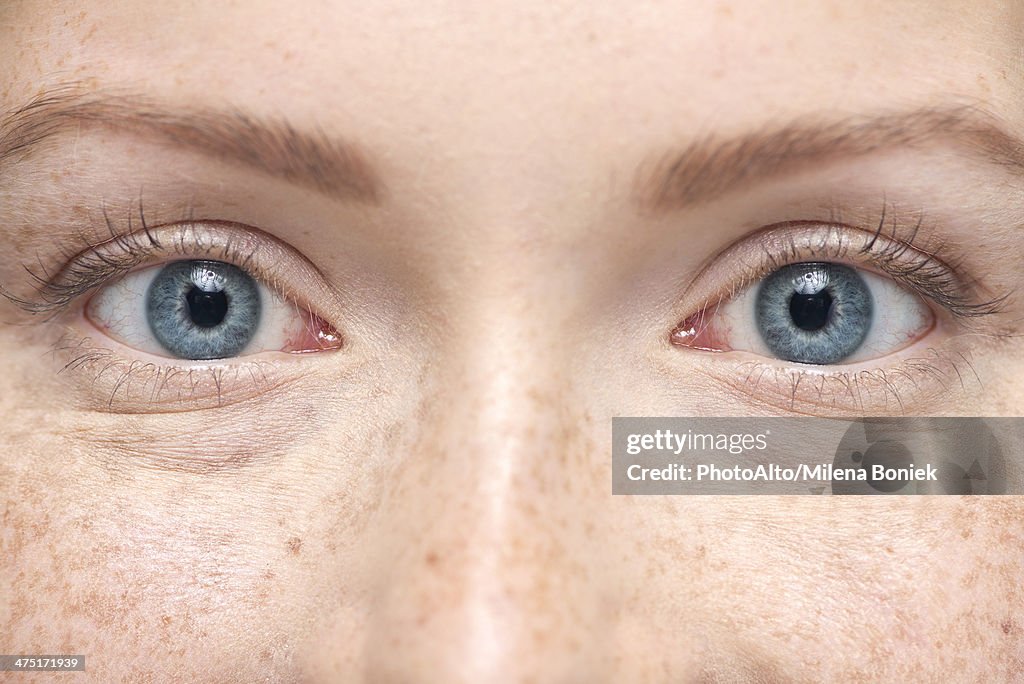 Young woman smiling, close-up portrait