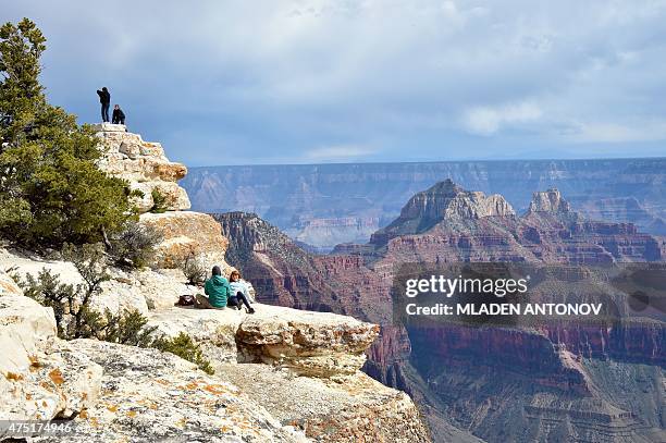 Tourists take photos from the North Rim of the Grand Canyon on May 18, 2015. AFP PHOTO/MLADEN ANTONOV