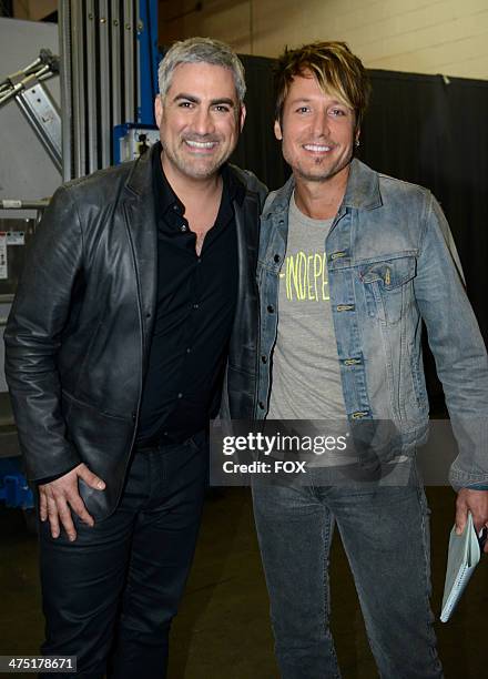 Judge Keith Urban is seen with American Idol's season 5 winner Taylor Hicks on FOX's "American Idol" Season 13 Top 13 Perform Live Show on February...