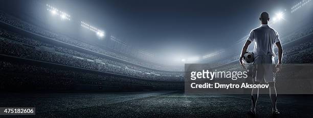soccer player with ball in stadium - football player stock pictures, royalty-free photos & images