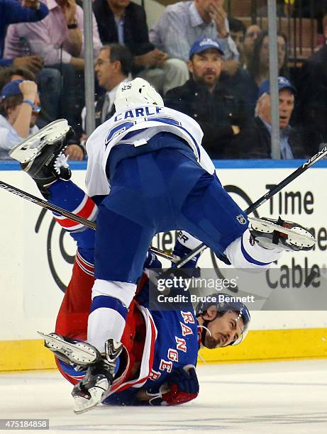 Matt Carle of the Tampa Bay Lightning checks Chris Kreider of the New York Rangers during the second period in Game Seven of the Eastern Conference...