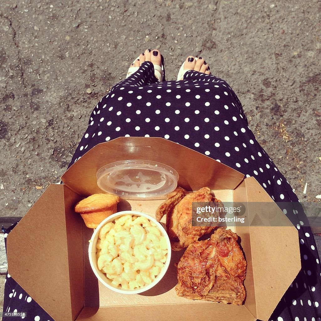 Woman with a Fried chicken take away