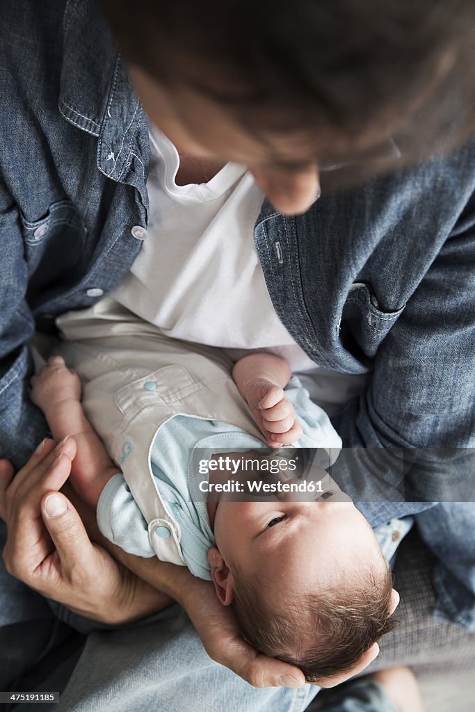 Young father holding his newborn son