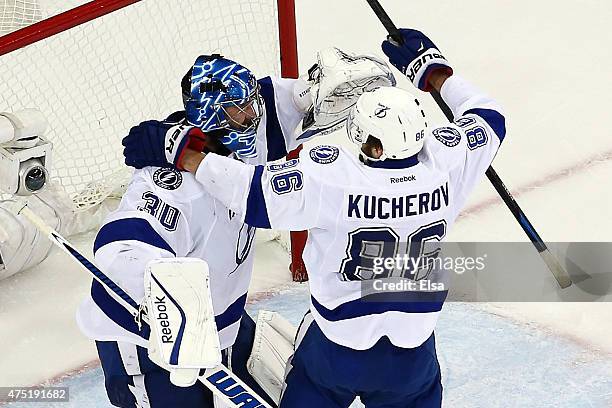 Ben Bishop of the Tampa Bay Lightning celebrates with teammate Nikita Kucherov after defeating the New York Rangers by a score of 2-0 to win Game...