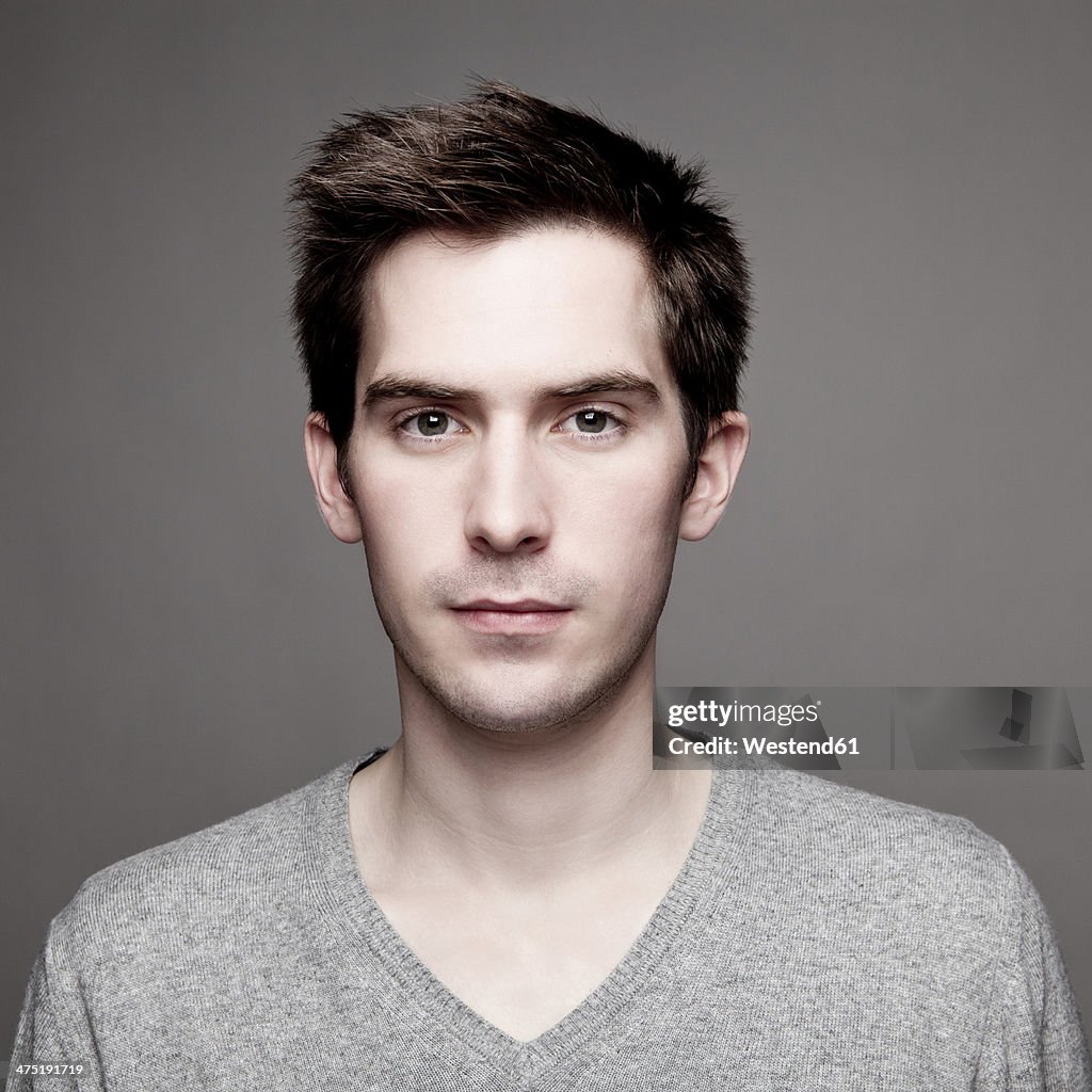 Portrait of serious looking young man, close-up