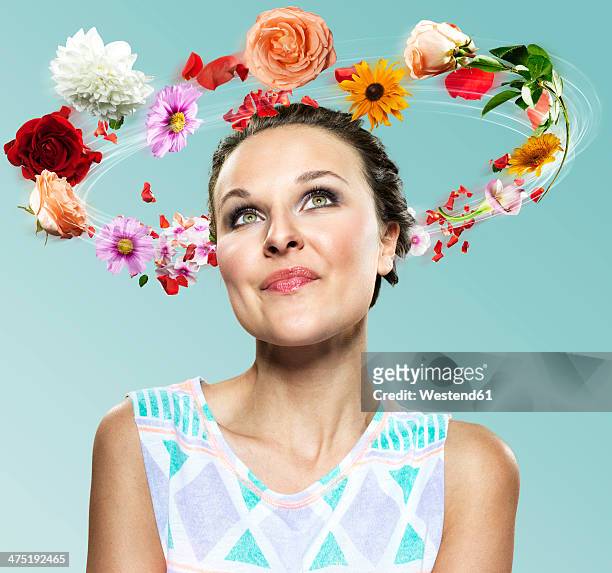 young woman with flying flowers around her head, composite - hovering fotografías e imágenes de stock