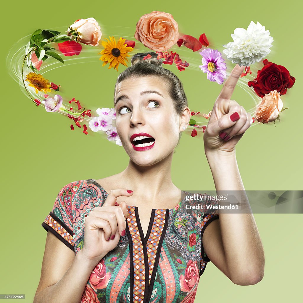 Young woman with flying flowers around her head, Composite
