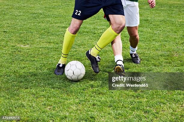 two soccer players on field - two guys playing soccer stockfoto's en -beelden