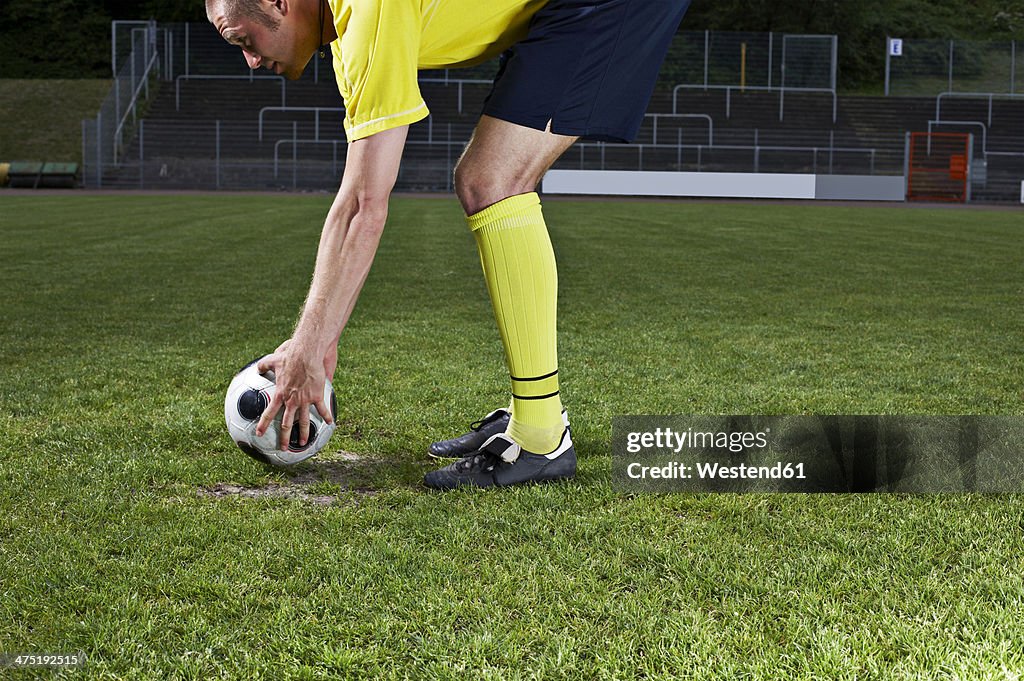 Soccer player placing ball on penalty spot