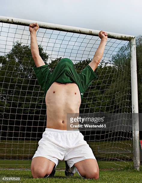 soccer player celebrating on field - scoring a goal stock-fotos und bilder