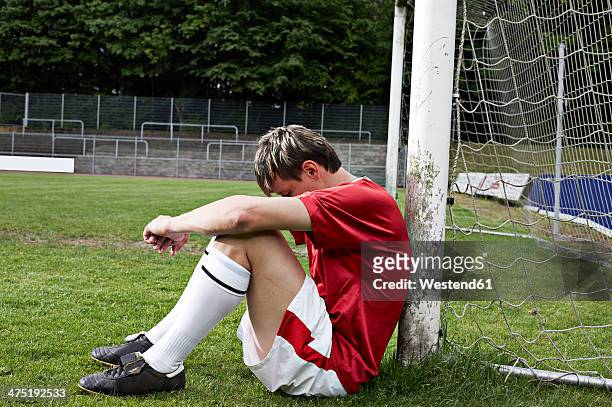 frustrated soccer player on field - blocking sports activity stock pictures, royalty-free photos & images