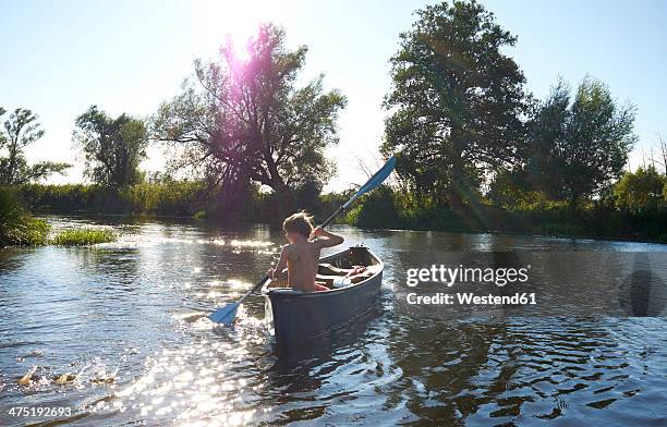 germany, brandenburg, boy paddeling on spree river - river spree stock pictures, royalty-free photos & images