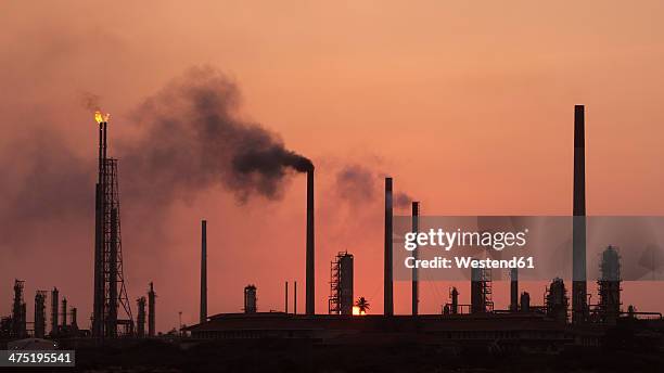 curacao, willemstad, old oil refinery at dusk - oil refinery stock pictures, royalty-free photos & images