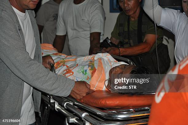 This photo taken on May 29, 2015 shows one of the injured victims of a bomb explosion near a mosque inside a police camp is wheeled into a hospital...