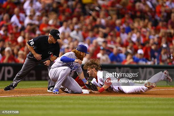 Mark Reynolds of the St. Louis Cardinals is caught stealing third base by Justin Turner of the Los Angeles Dodgers as umpire Mike Muchlinski looks on...