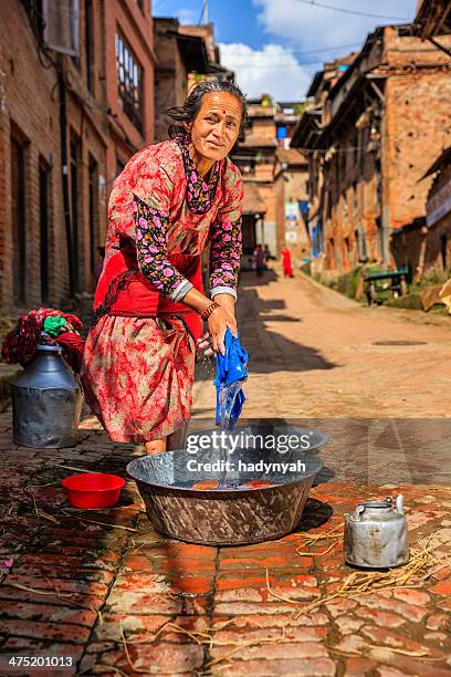 nepali woman washing clothes on the street in bhaktapur - nepal road bildbanksfoton och bilder