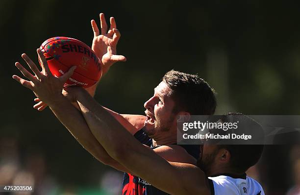 Jesse Hogan of the Demons marks the ball against Alipate Carlile of the Power during the round nine AFL match between the Melbourne Demons and the...