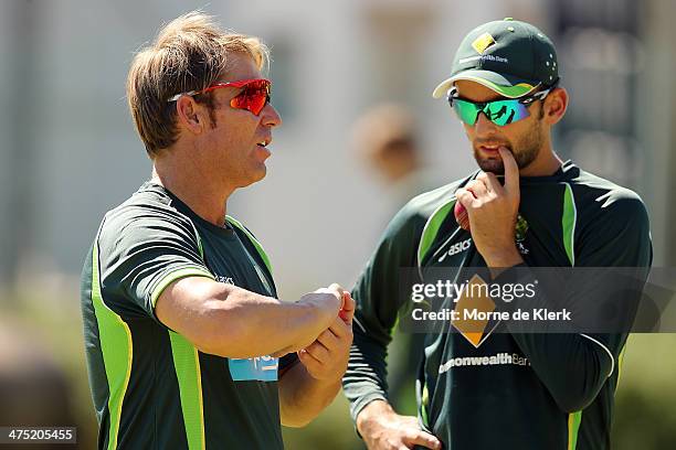 Shane Warne speaks to Nathan Lyon during an Australian nets session at Newlands Stadium on February 27, 2014 in Cape Town, South Africa.