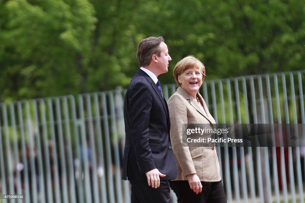Chancellor Angela Merkel (right ) welcomes British Prime...