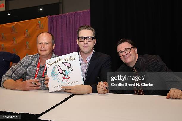 Illustrator Dan Krall, authors Devlin Elliott and Nathan Lane pose for photographs with their newest book during BookExpo America held at the Javits...