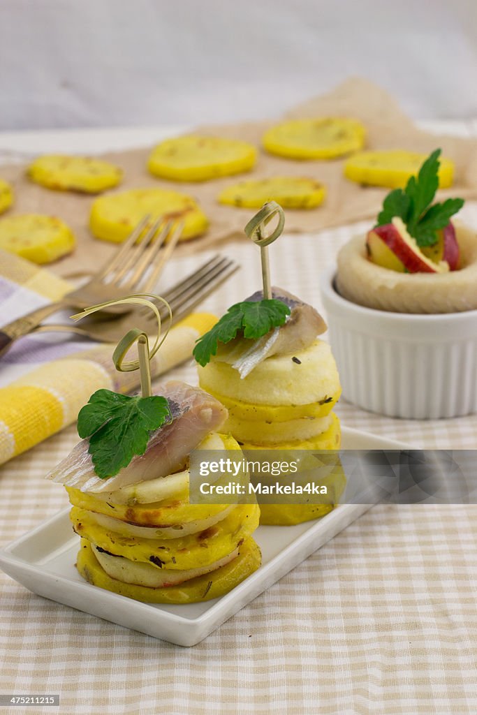 Appetizer towers with slices of potato and apple