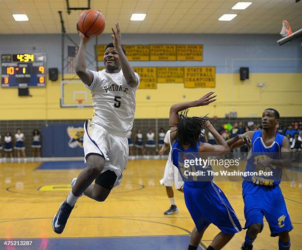 Potomac's Dion Wiley, left, breaks past Thomas Stone defenders Jordan Battle, center, and Tony Doublin for a 1st half score as Potomac defeats Thomas...