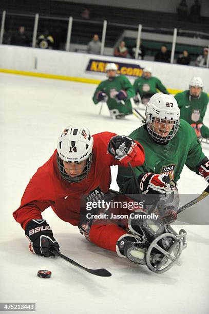 Paralympic Sled Hockey Team athletes Daniel McCoy , and Josh Pauls fight for control of a loose puck during training at the Sertich Ice Arena on...