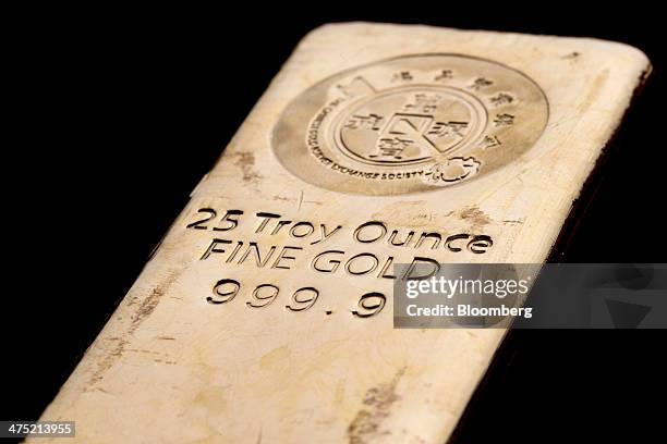 Troy ounce gold bar is arranged for a photograph at the Chinese Gold and Silver Exchange Society in Hong Kong, China, on Wednesday, Feb. 26, 2014....