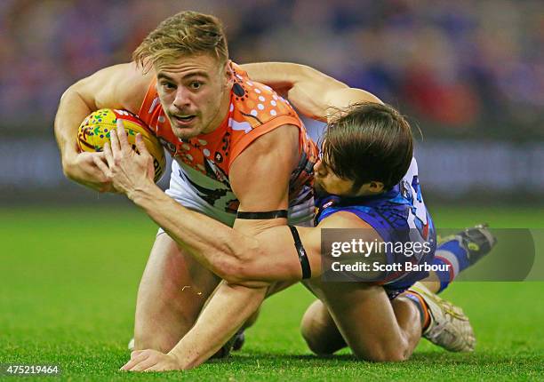 Stephen Coniglio of the Giants is tackled by Easton Wood of the Bulldogs during the round nine AFL match between the Western Bulldogs and the Greater...