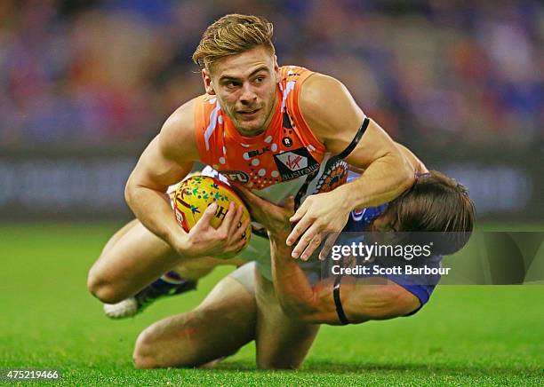 Stephen Coniglio of the Giants is tackled by Easton Wood of the Bulldogs during the round nine AFL match between the Western Bulldogs and the Greater...