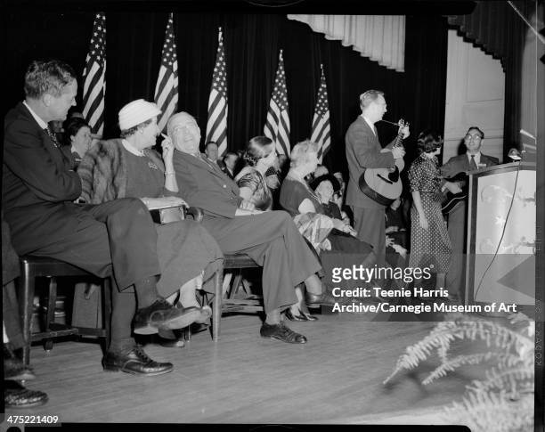 Two men with acoustic guitars and woman at podium, on stage with seated men and women Including from left: Joseph S Clark, Alyce Lawrence, Pittsburgh...