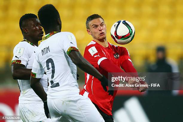 Bernd Gschweidl of Austria is challenged by Emmanuel Ntim of Ghana during the FIFA U-20 World Cup New Zealand 2015 Group B match between Ghana and...