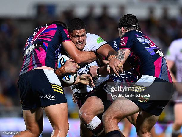 Willie Mason of the Sea Eagles is tackled by Sam Hoare and Ethan Lowe of the Cowboys during the round 12 NRL match between the North Queensland...