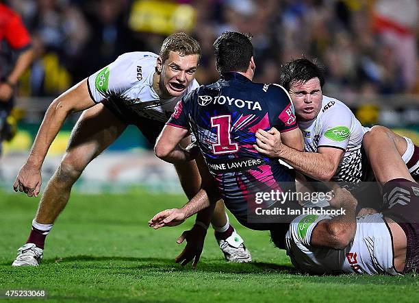 Lachlan Coote of the Cowboys is tackled by Jamie Lyon of the Sea Eagles during the round 12 NRL match between the North Queensland Cowboys and the...