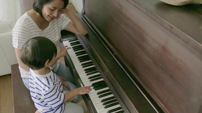 30 Mother And Son Sitting Together Playing Piano Stock Videos Footage 30-mother-and-son-sitting-together-playing-piano-stock-videos-footage