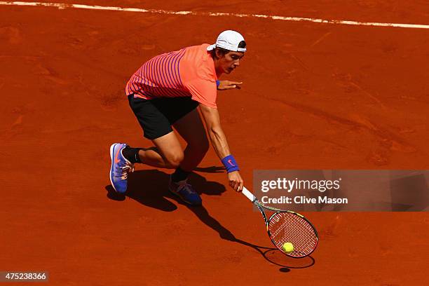 Thanasi Kokkinakis of Australia returns a shot in his Men's Singles match against Novak Djokovic of Serbia on day seven of the 2015 French Open at...