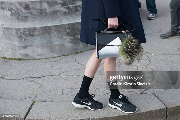 Model Ming Xi wears Celine coat, Fendi bag and Nike trainers on day 2 of Paris Collections: Women on February 26, 2014 in Paris, France.