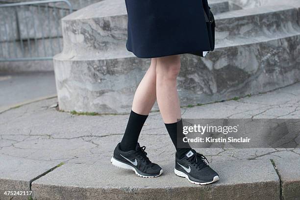 Model Ming Xi wears Celine coat and Nike trainers on day 2 of Paris Collections: Women on February 26, 2014 in Paris, France.