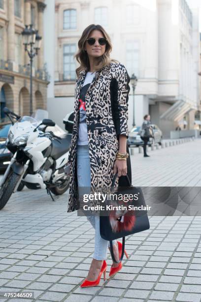 Helena Bordon wears a Pedro Lorenzo coat, Current Elliott jeans, Fendi Monster pom pom, Rock top, Rayban sunglasses, Maria Sole bag on day 2 of Paris...