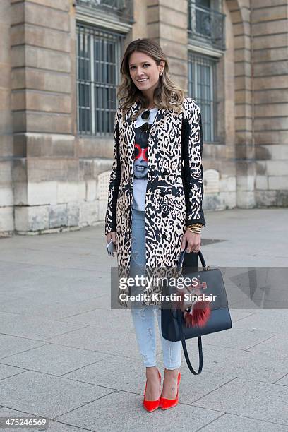 Helena Bordon wears a Pedro Lorenzo coat, Current Elliott jeans, Fendi Monster pom pom, Rock top, Rayban sunglasses, Maria Sole bag on day 2 of Paris...