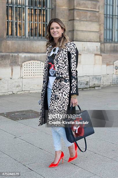 Helena Bordon wears a Pedro Lorenzo coat, Current Elliott jeans, Fendi Monster pom pom, Rock top, Rayban sunglasses, Maria Sole bag on day 2 of Paris...