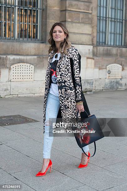 Helena Bordon wears a Pedro Lorenzo coat, Current Elliott jeans, Fendi Monster pom pom, Rock top, Rayban sunglasses, Maria Sole bag on day 2 of Paris...