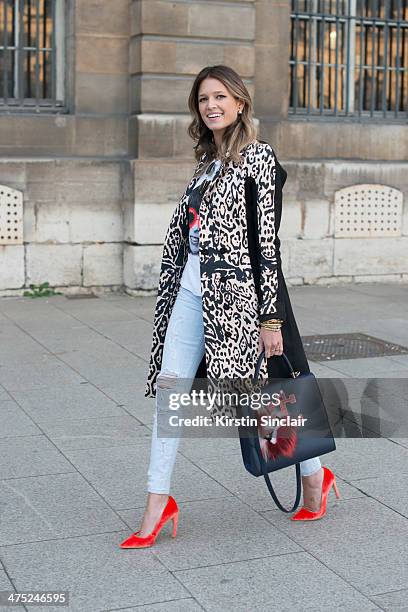 Helena Bordon wears a Pedro Lorenzo coat, Current Elliott jeans, Fendi Monster pom pom, Rock top, Rayban sunglasses, Maria Sole bag on day 2 of Paris...