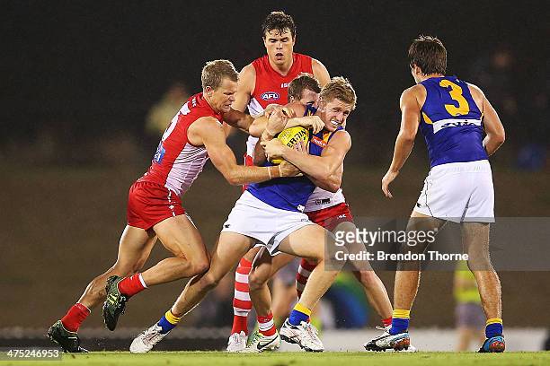 Scott Selwood of the Eagles is tackled by Ryan O'Keefe of the Swans during the round three NAB Challenge match between the Sydney Swans and the West...