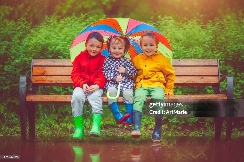 Chilren under umbrella