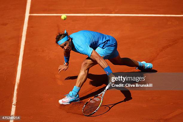 Rafael Nadal of Spain returns a shot in his Men's Singles match against Andrey Kuznetsov of Russia on day seven of the 2015 French Open at Roland...